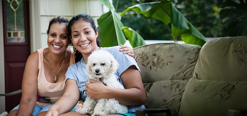 photo of two women and a small dog